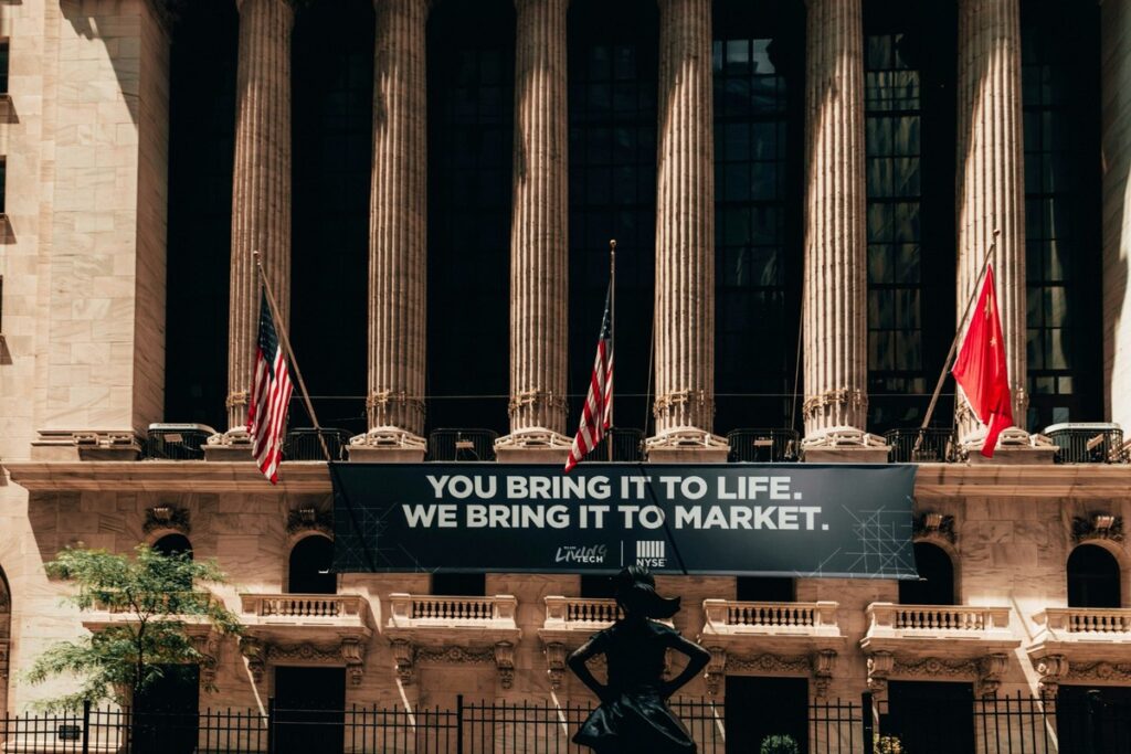 New York Stock Exchange facade with flags and a market banner