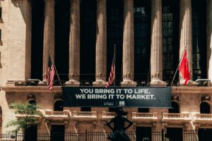 New York Stock Exchange facade with flags and a market banner